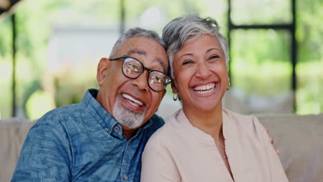 Love,-face-and-happy-senior-couple-on-a-sofa-hug