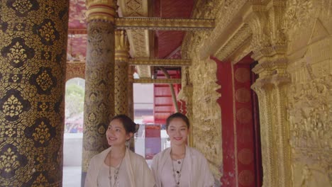 asian girls in lao traditional costume walking in temple, slow motion