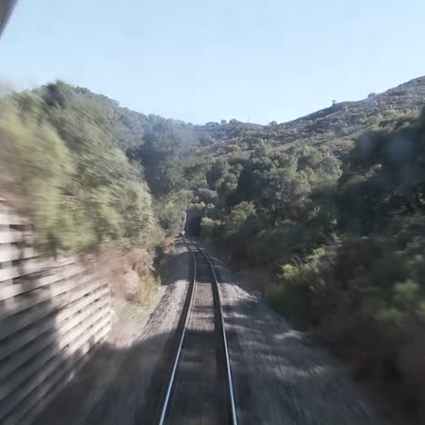 Exciting-POV-shot-point-of-view-of-a-train-down-tracks-and-into-a-tunnel