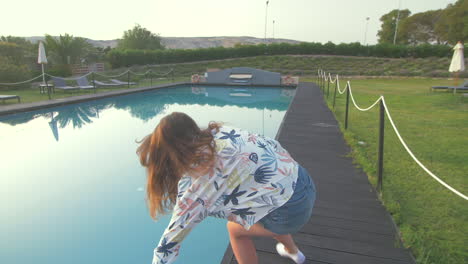 woman relaxing by the pool on a sunny summer day