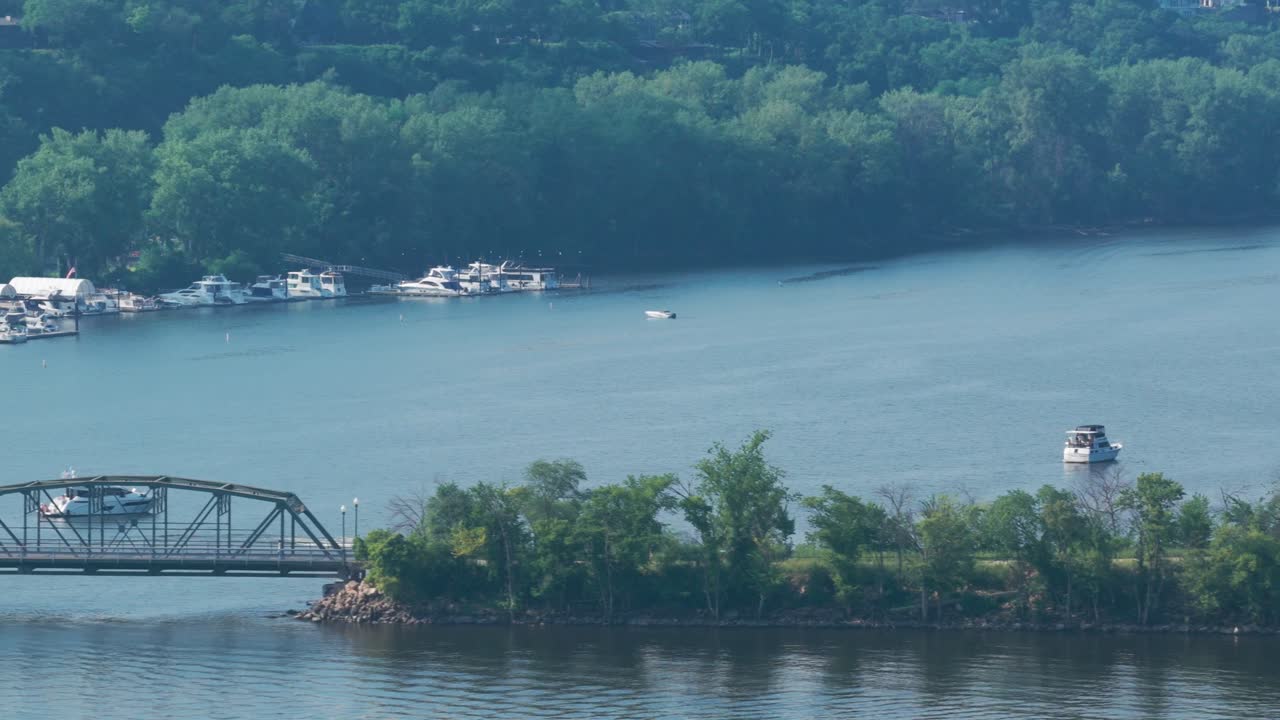 Aerial telephoto close-up dolly shot of the Stillwater Lift Bridge from the Wisconsin side to the Minnesota side on the St. Croix River in Stillwater, Minnesota. 4K