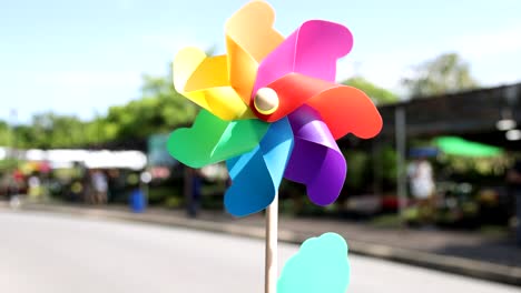 pinwheel rotates rapidly at an outdoor market.