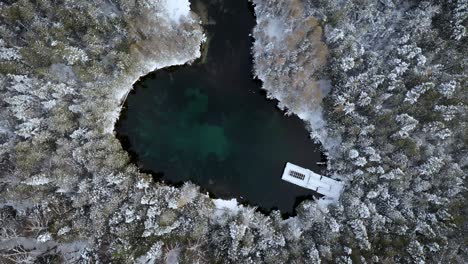 winter aerial of kitch-iti-kipi in the up of michigan