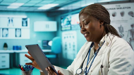 black physician looking over clinical records to find treatment in her cabinet