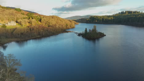 colorful sunset over the hills in autumn colors at loch achray island