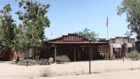 old wooden saddlery building in desert western style ghost town in the middle of summer