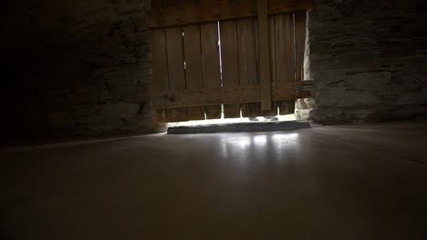 young boy walking into a barn