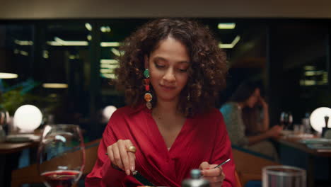 african american girl eating tasty meal in fine dining place. restaurant concept