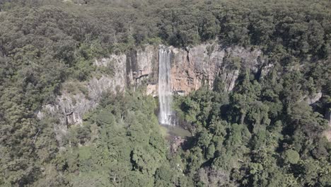 aerial view of a stunning waterfall in a lush forest