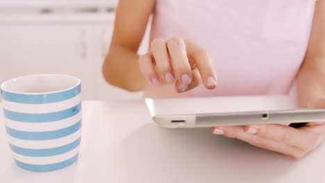 Woman-using-tablet-on-a-table