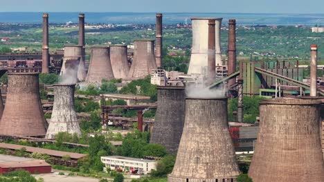 aerial view of a large industrial complex with cooling towers and smokestacks