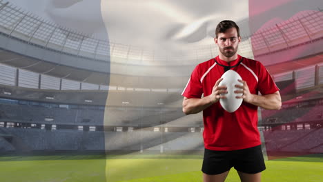 professional rugby player standing in front of a flag and stadium