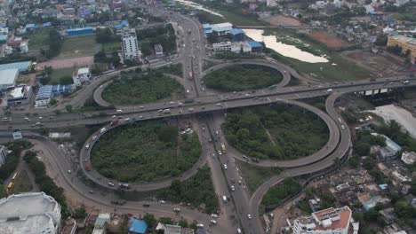 an aerial view of the chennai maduravoyal cloverleaf flyover demonstrates vehicle movements