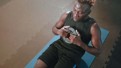 man doing weighted sit-ups