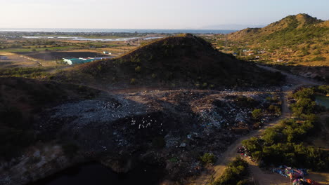 Aerial-view-of-a-landfill-rubbish-dump-in-open-air-mountains-of-Vietnam