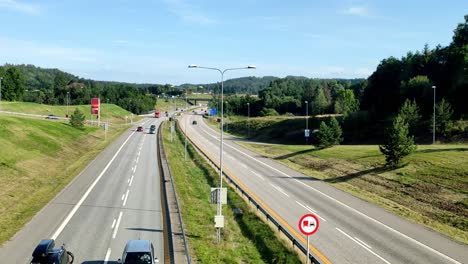 static shot of a highway in norway with cars driving on a sunny day