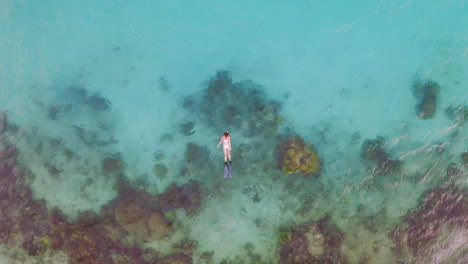 an-unrecognizable-woman-snorkelling-in-the-sea