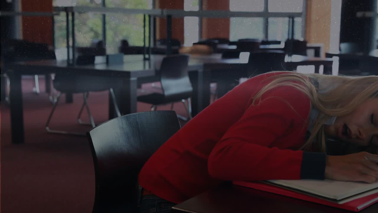 Student dozing, head settling and pen closing, bar charts growing across sweater showing study data