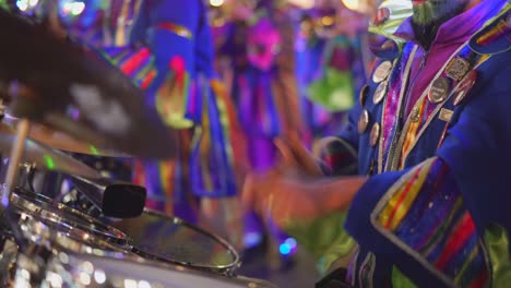 funny disguised drummer performing with drums on carnival event on stage,close up shot