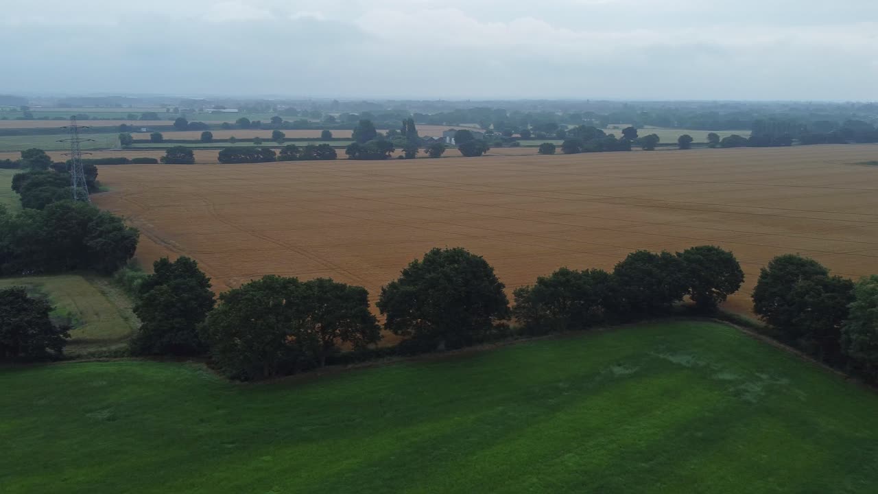 Hazy morning across UK British farming countryside rolling agriculture aerial view landscape