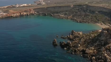 drone shot pulling away from from cirkewwa gozo ferry malta