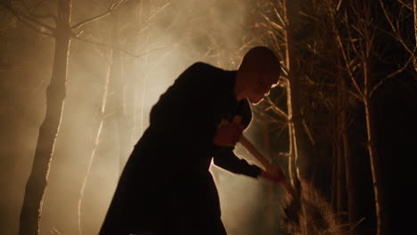 silhouette of person in dark forest at night