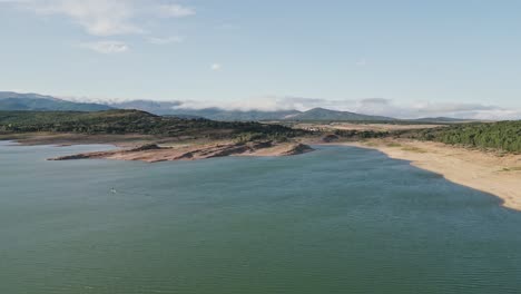 aerial view of a water reservoir at sunset with low water level in summer in spain