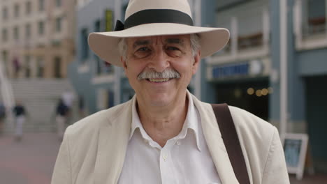 portrait of stylish elderly man smiling enjoying vacation sightseeing wearing white suit and hat travel tourism