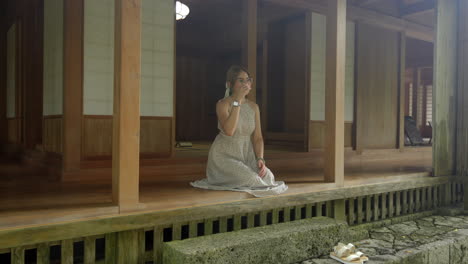 latin woman with glasses relax and peaceful at traditional garden house okinawa tamaudun japan breathing meditation