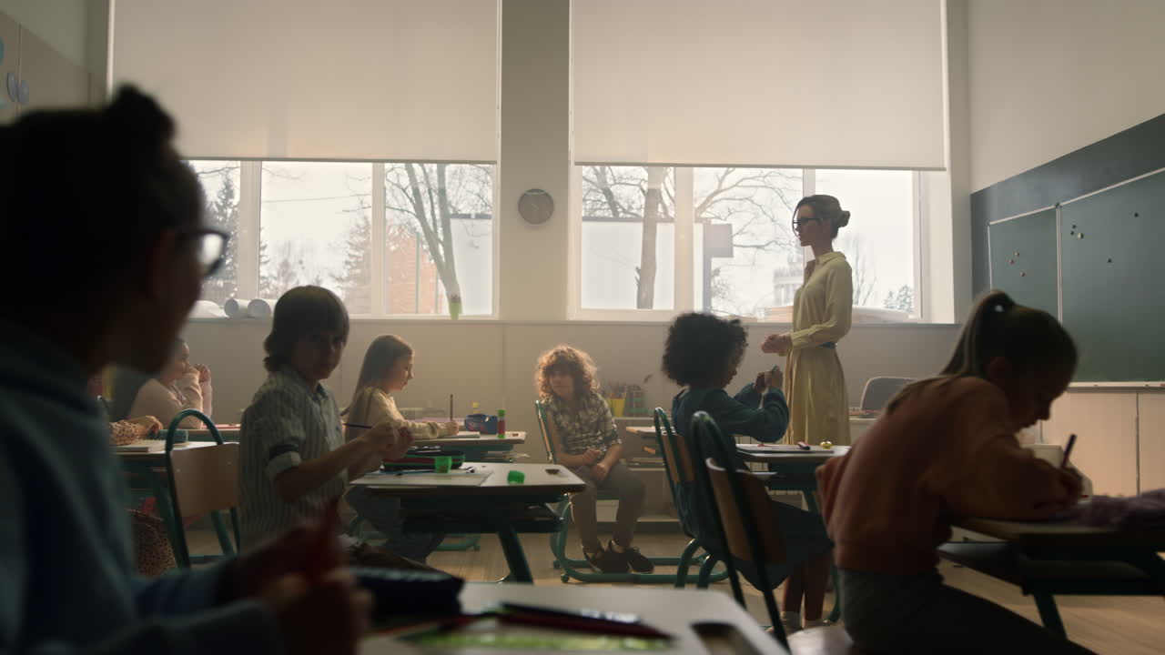 Students learning in classroom. Smart pupils writing in notebooks during lesson