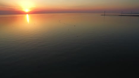 Aerial:-The-beach-around-the-Oosterschelde-storm-surge-barrier-during-a-summer-sunset