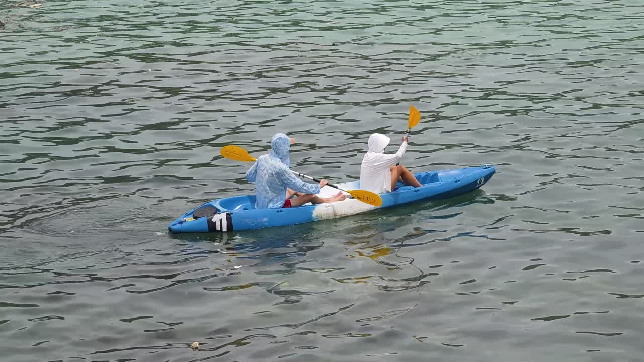 Two people kayaking in calm water