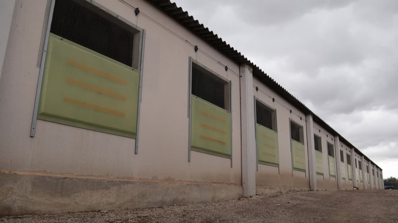 Exterior of building with windows and columns in countryside