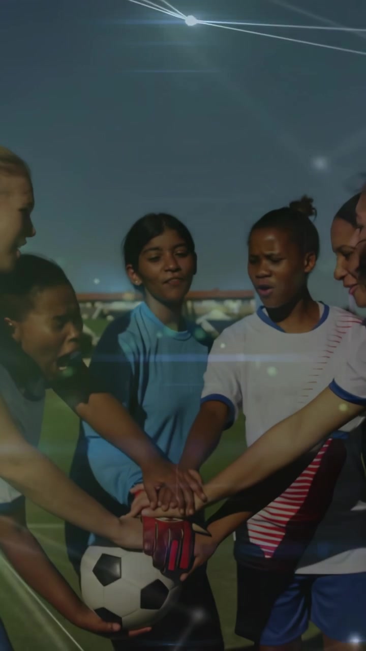 Vertical video: Ball holder initiating hand stack on ball female soccer players building team unity