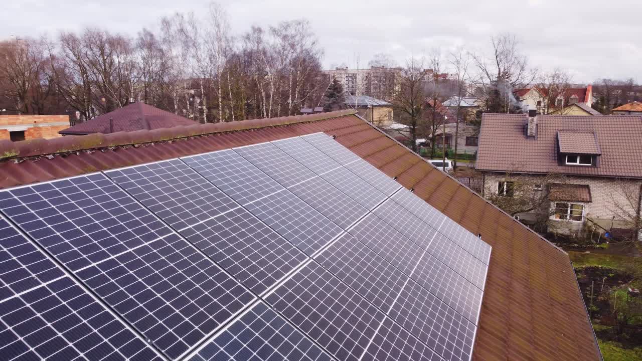 Solar panels mounted on tiled roof for renewable energy source, aerial closeup