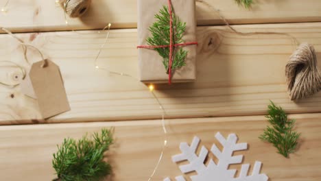 video of christmas decorations with presents and tag on wooden background