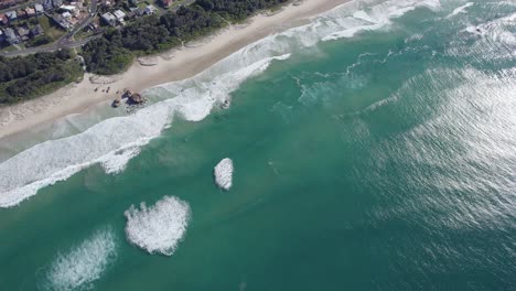 Foamy-Waves-Splashing-On-Sandy-Shore-Of-Lighthouse-Beach-In-Port-Macquarie,-NSW,-Australia---drone-shot