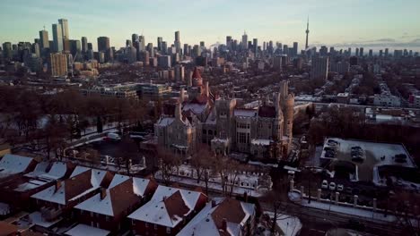 Toronto-City-Skyline-and-Casa-Loma-Tourist-Destination,-Epic-Drone-Pull-Back