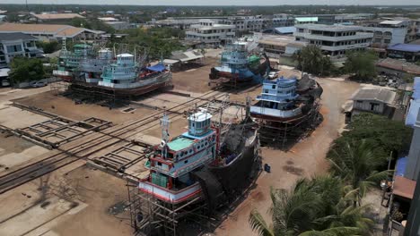 fishing boats undergoing repair and maintenance in a boatyard