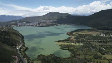 Lake-formed-from-glacial-meltwater-near-mountains,-aerial,-Yawarkucha,-Ecuador