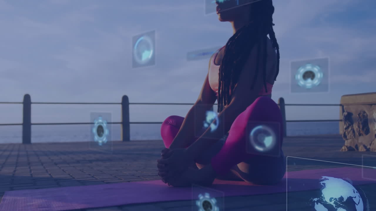 Practicing yoga on mat, woman with animation of digital data graphics overlay