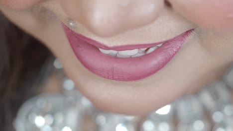 woman with pink lipstick and jewelry