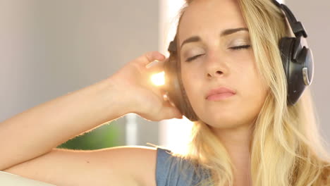 beautiful blonde teen relaxing and listening to music