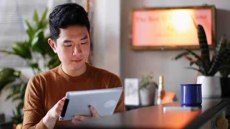 man using digital tablet on kitchen counter 4k