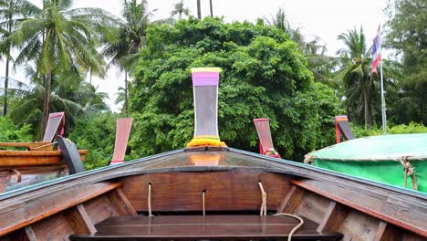 boat navigating through rain in lush krabi