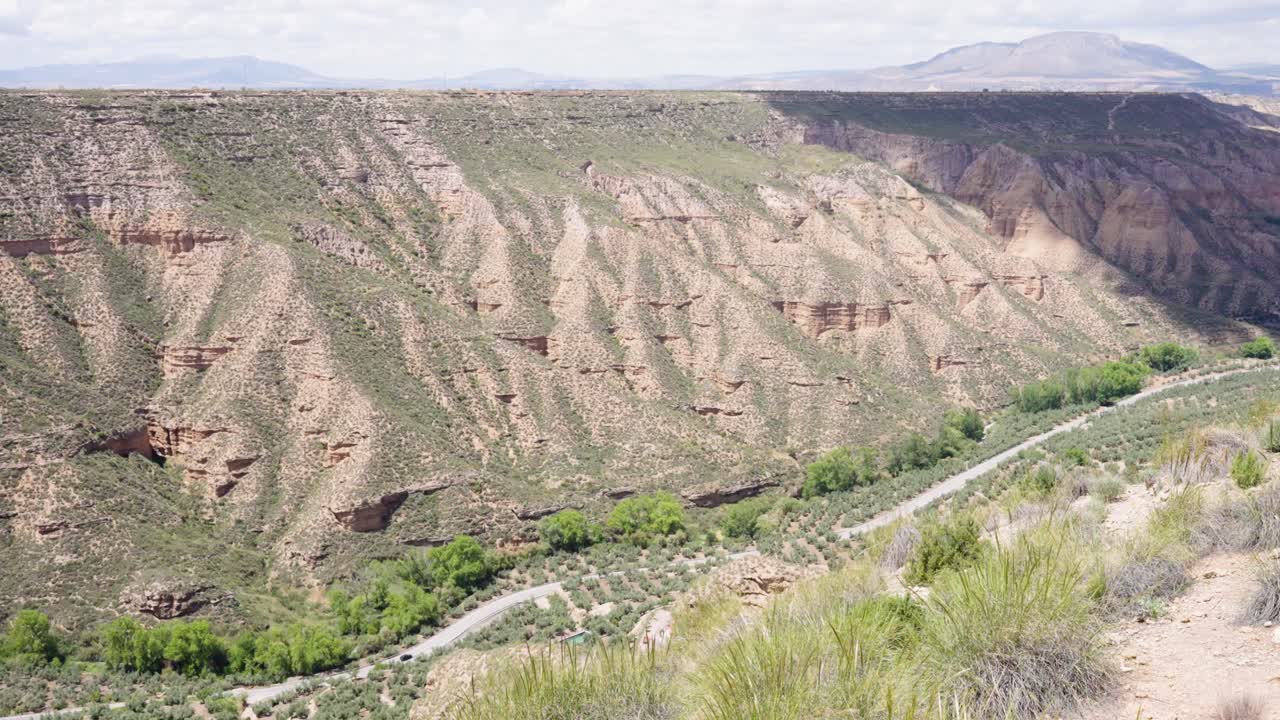 Gorafe desert landscape showing erosion and a road in the valley
