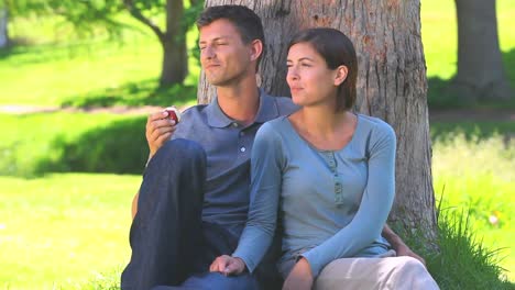 young couple sharing an apple