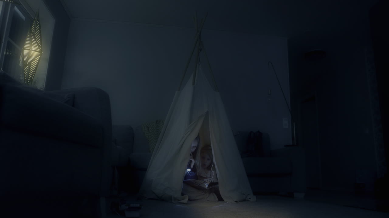 Video of Kids secretly awake Reading Fairy Tales in a tent at Night