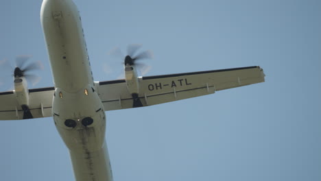 looking straight up at a propellor airplane flying by