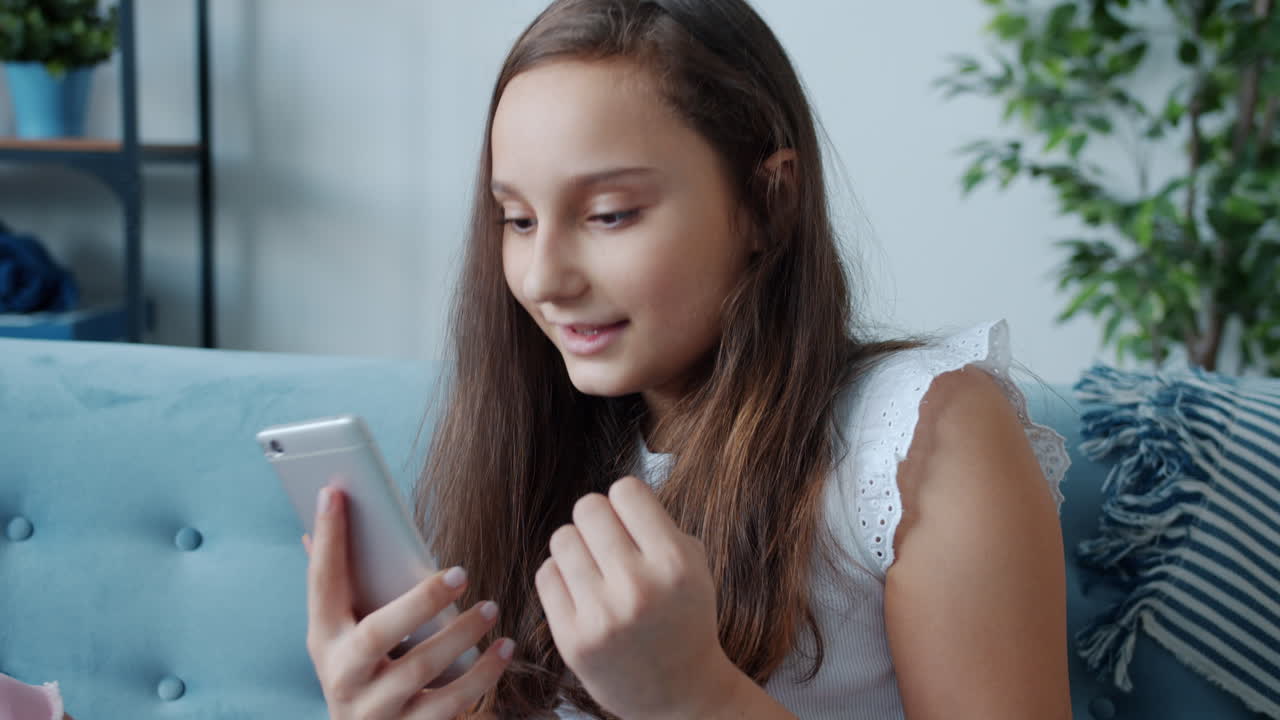 Teenage Girl Using Smartphone on Couch